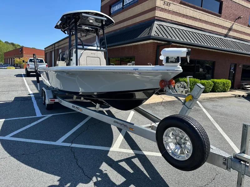 Slide: The Image of 2022 Sea Pro 248 DLX boat on trailer in parking lot, near brick building. - 5