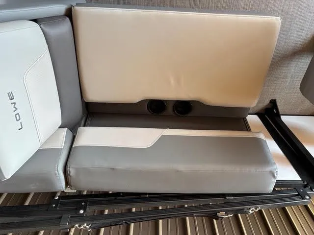 Slide: The Image of Lowe LS210 2025 boat seat with cup holders, featuring gray and white upholstery. - 11