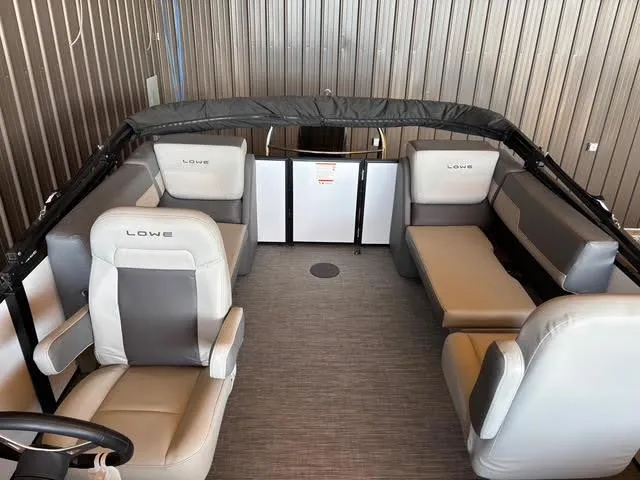 Slide: The Image of 2025 Lowe LS210 boat interior with gray seating and modern design. - 12