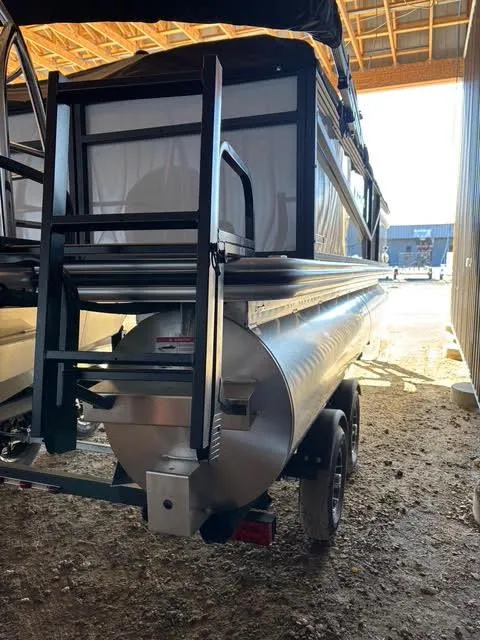 Slide: The Image of 2025 Lowe LS210 pontoon boat rear view in a storage area. - 6