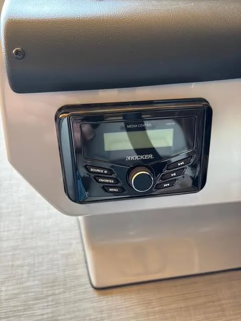 Slide: The Image of Kicker media center in a 2025 Lowe LS210 boat dashboard. - 7