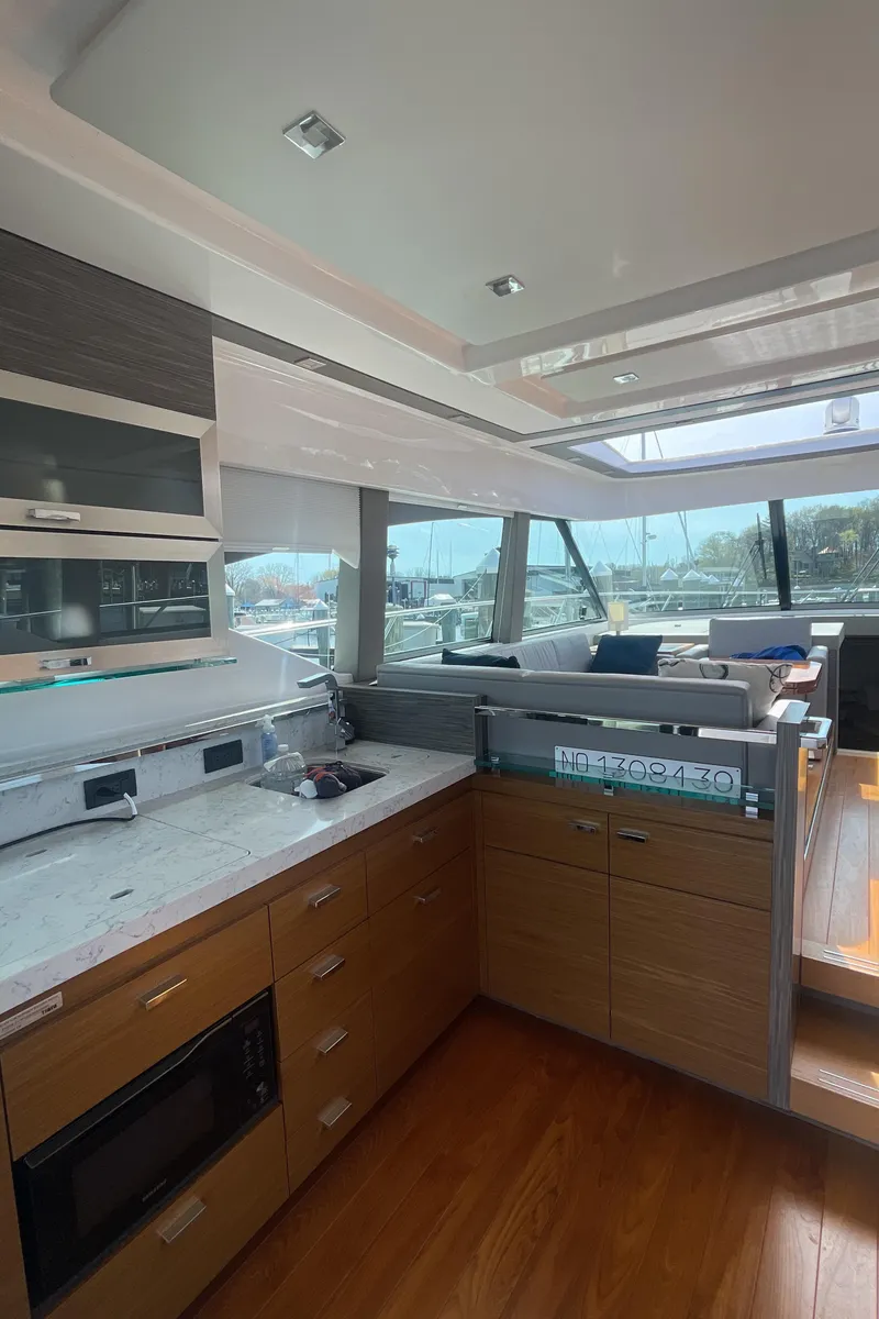 Slide: The Image of Interior of 2020 Tiara Yachts 53 Coupe with modern kitchen and panoramic windows. - 11
