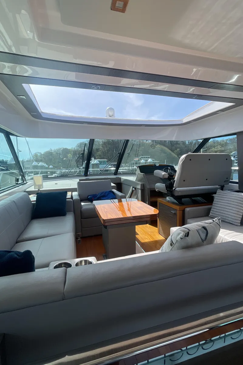 Slide: The Image of Interior of 2020 Tiara Yachts 53 Coupe with skylight and luxurious seating. - 14