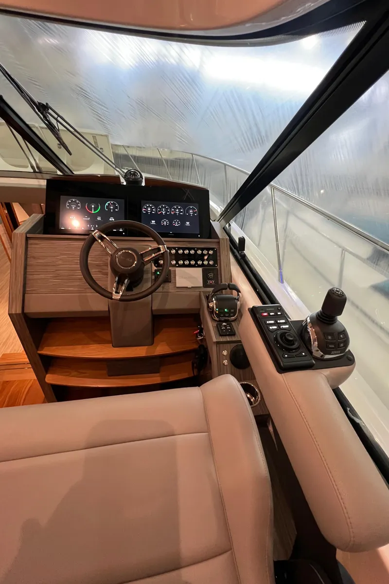 Slide: The Image of 2020 Tiara Yachts C53 Coupe helm with modern controls and navigation displays. - 18