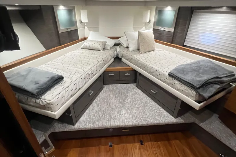 Slide: The Image of 2020 Tiara Yachts C53 Coupe cabin with twin beds and modern decor. - 21