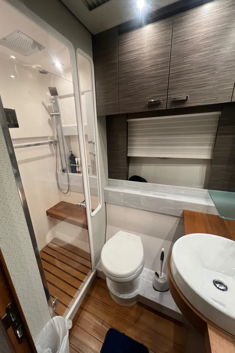 Slide: The Image of Modern bathroom in 2020 Tiara Yachts C53 Coupe with shower, toilet, and sink. - 29