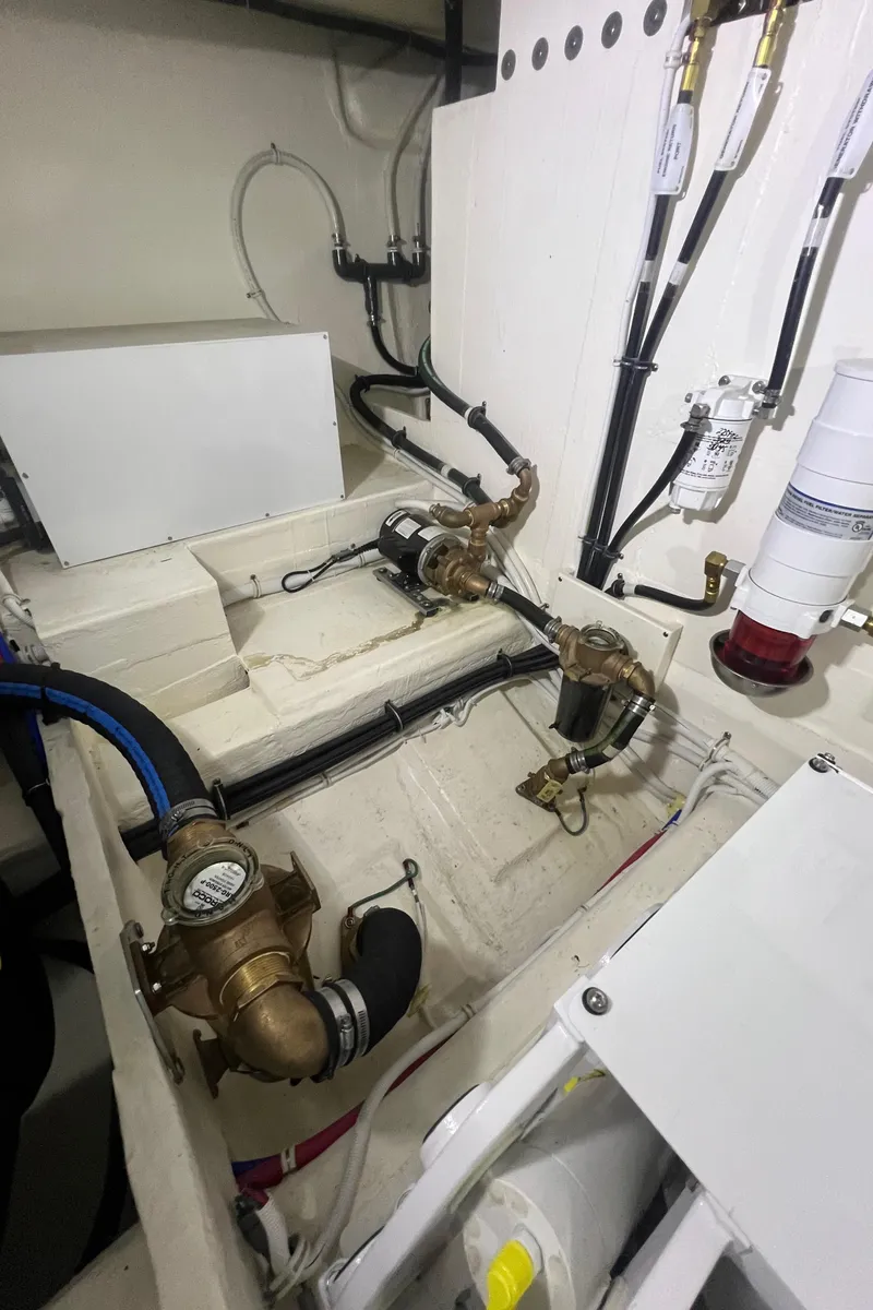 Slide: The Image of Engine room of 2020 Tiara Yachts C53 Coupe, showcasing mechanical components and piping. - 34