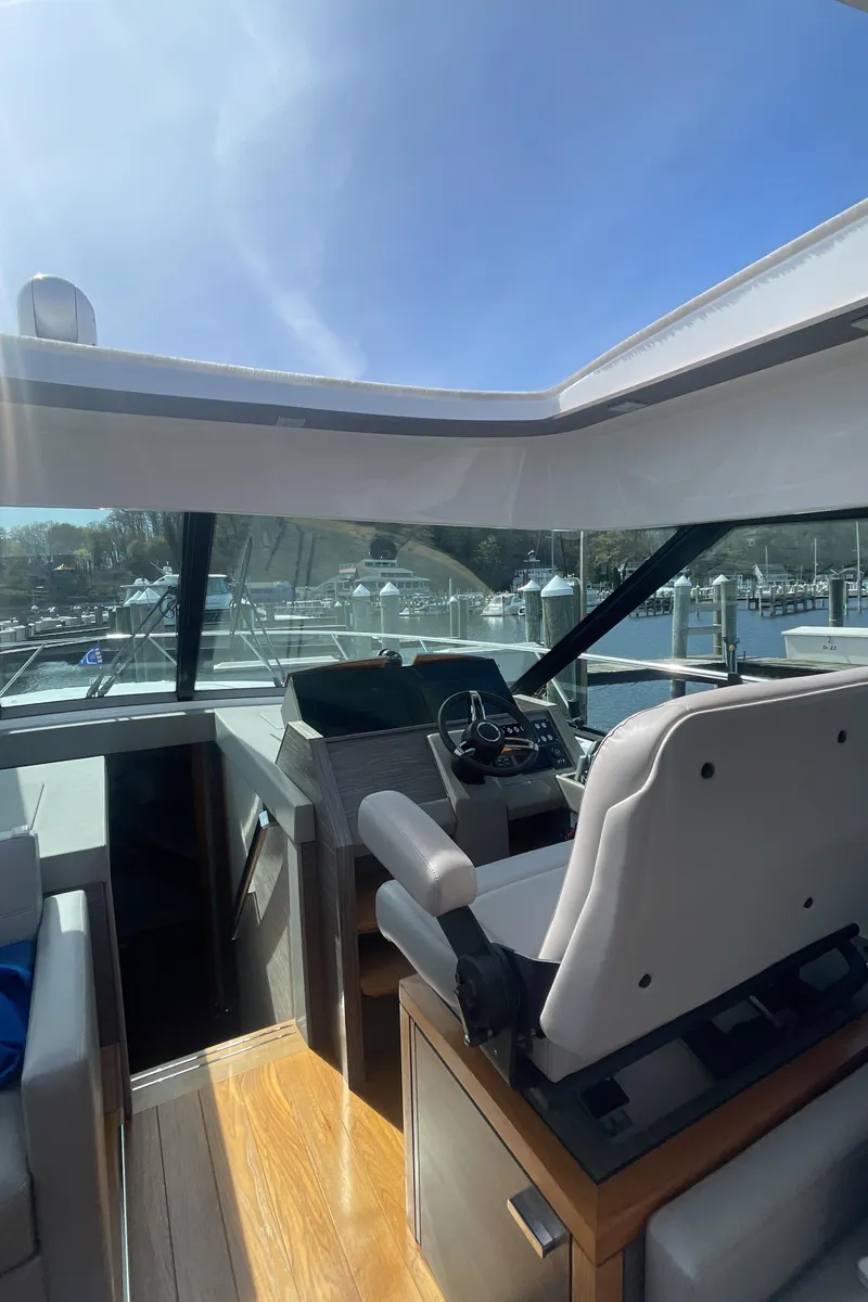 Slide: The Image of 2020 Tiara Yachts 53 Coupe interior helm with modern design and panoramic windows. - 37