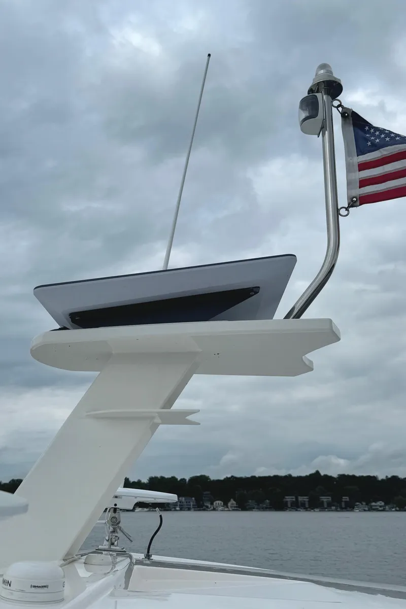 Slide: The Image of 2020 Tiara Yachts C53 Coupe with American flag, cloudy sky background. - 41