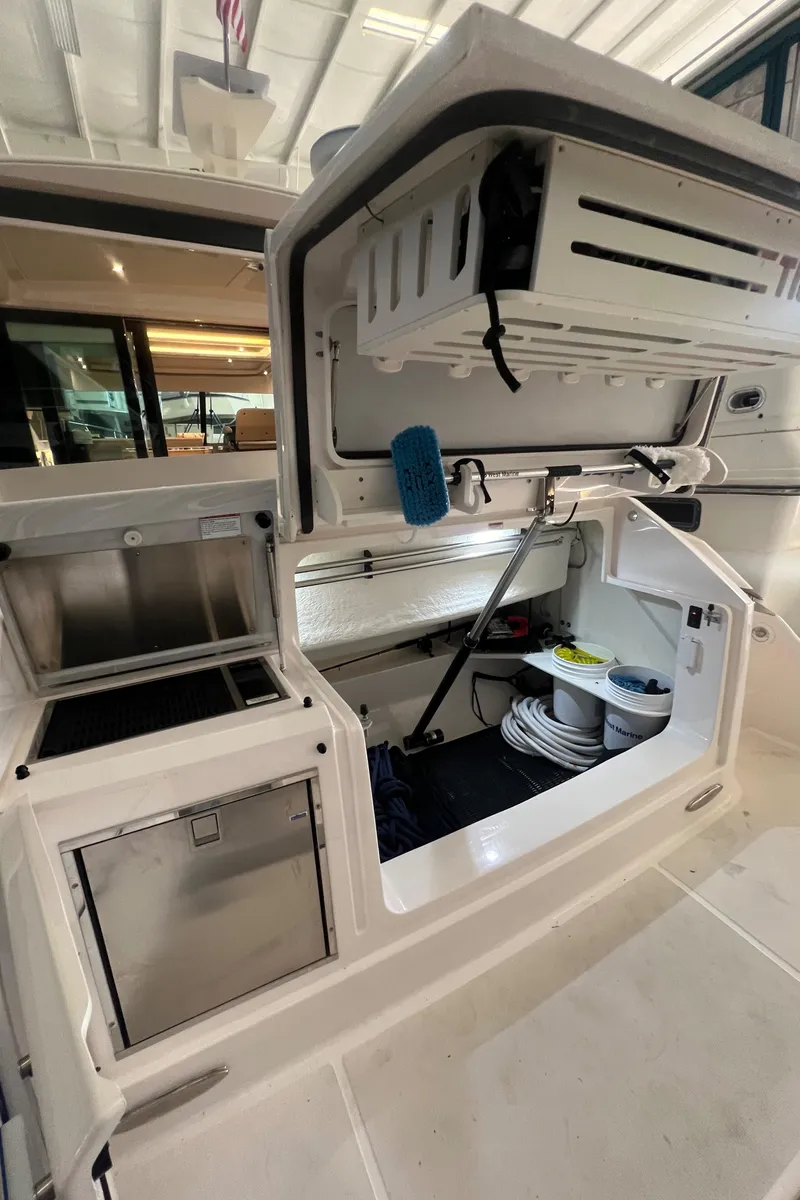 Slide: The Image of 2020 Tiara Yachts C53 Coupe storage compartment with organized equipment and supplies. - 6
