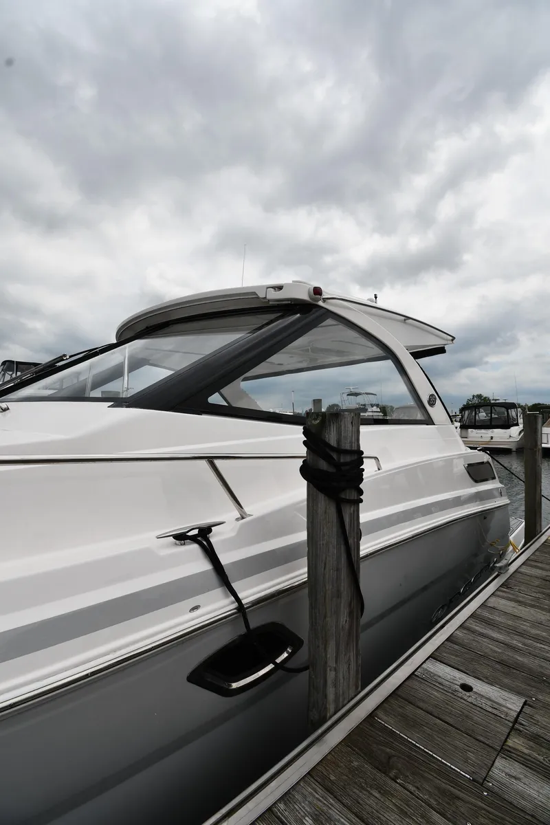Slide: The Image of 2021 Regal 35 Sport Coupe docked under cloudy skies. - 1