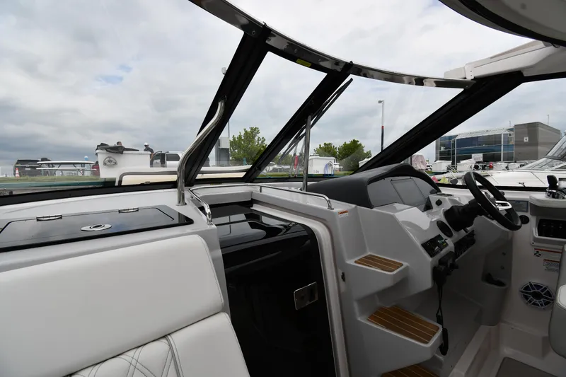 Slide: The Image of 2021 Regal 35 Sport Coupe cockpit with modern controls and seating, under cloudy sky. - 10