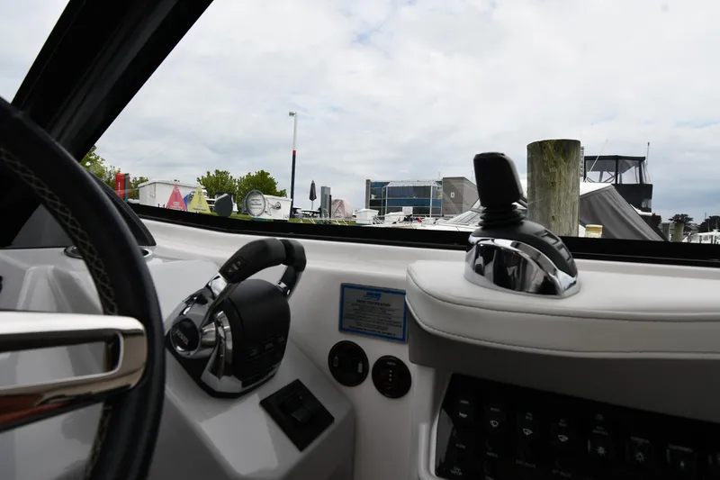 Slide: The Image of Interior view of 2021 Regal 35 Sport Coupe boat cockpit with steering and controls. - 15