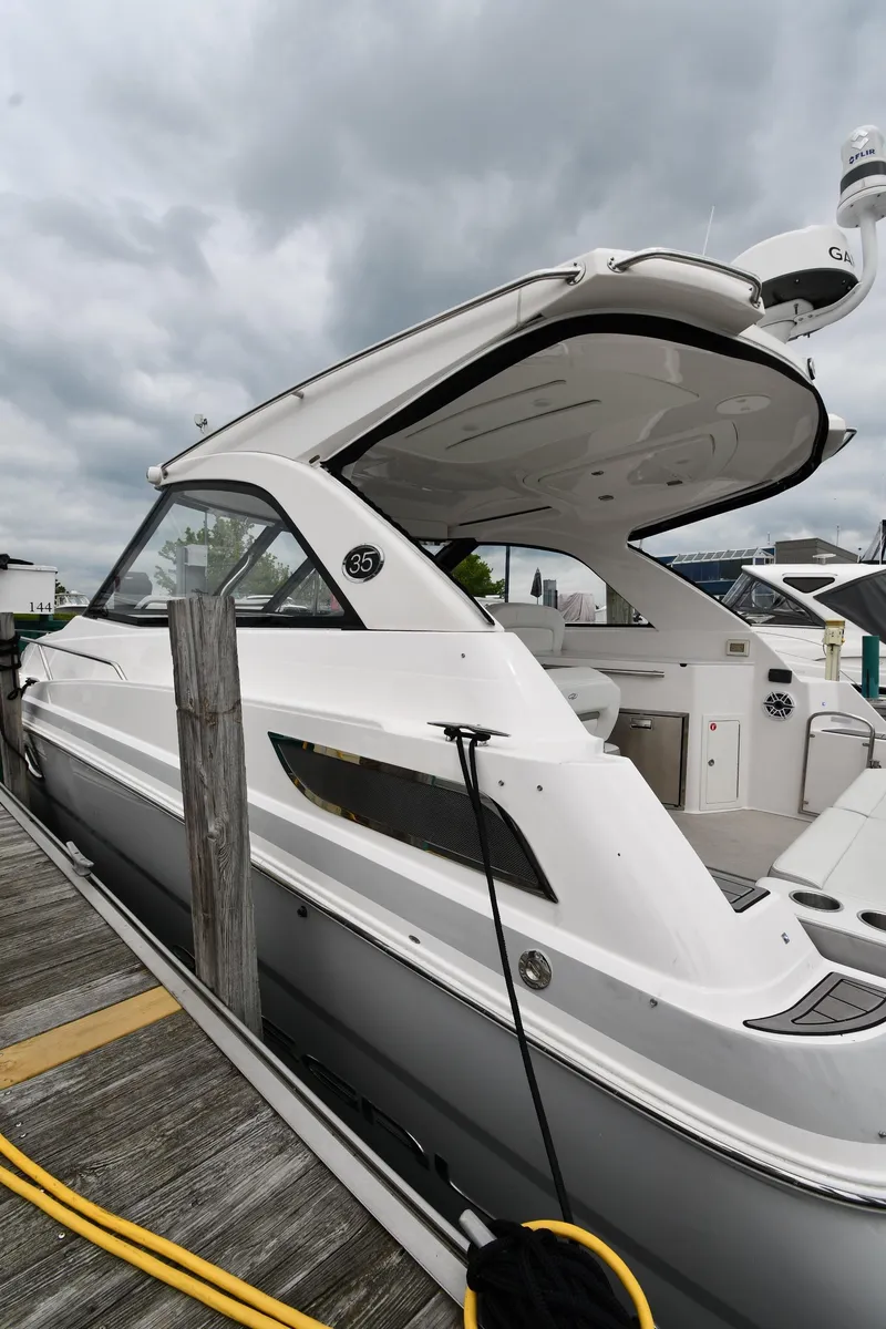 Slide: The Image of 2021 Regal 35 Sport Coupe docked, showcasing sleek design and modern features. - 2
