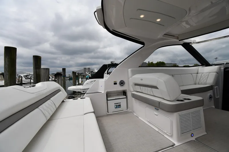Slide: The Image of 2021 Regal 35 Sport Coupe interior with plush seating and modern design at a marina. - 20