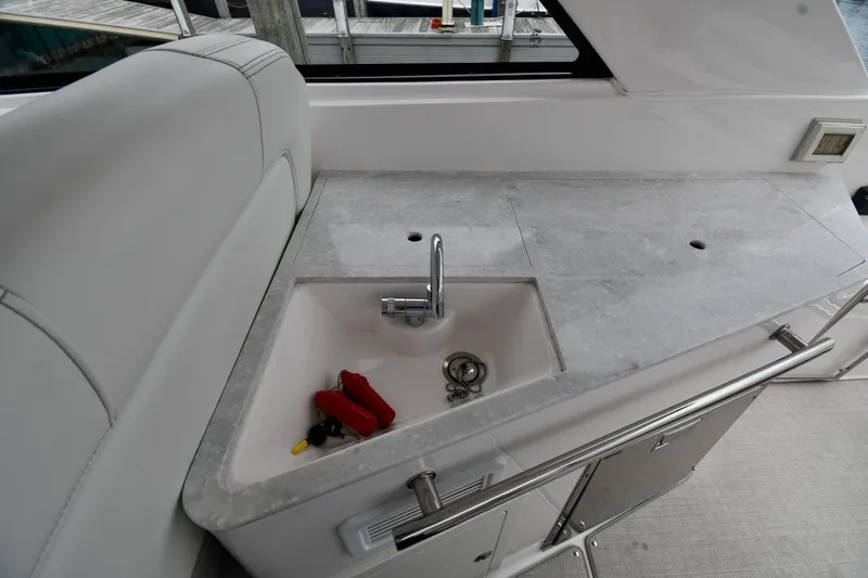 Slide: The Image of 2021 Regal 35 Sport Coupe yacht interior with sink and countertop. - 25