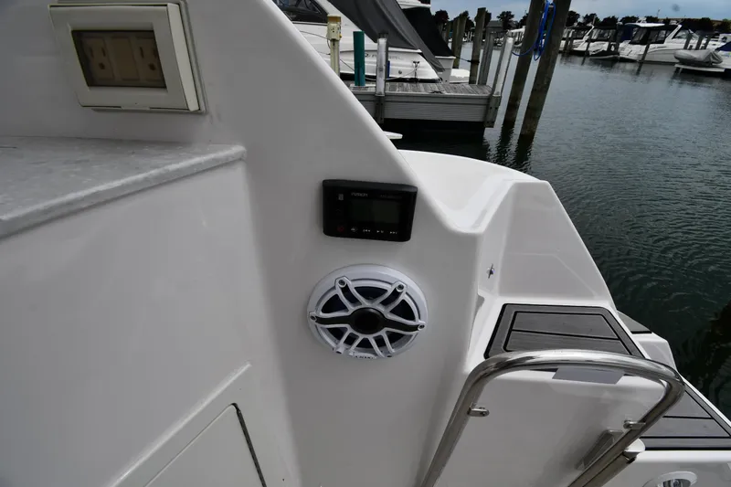 Slide: The Image of 2021 Regal 35 Sport Coupe boat with speaker and control panel at marina. - 26
