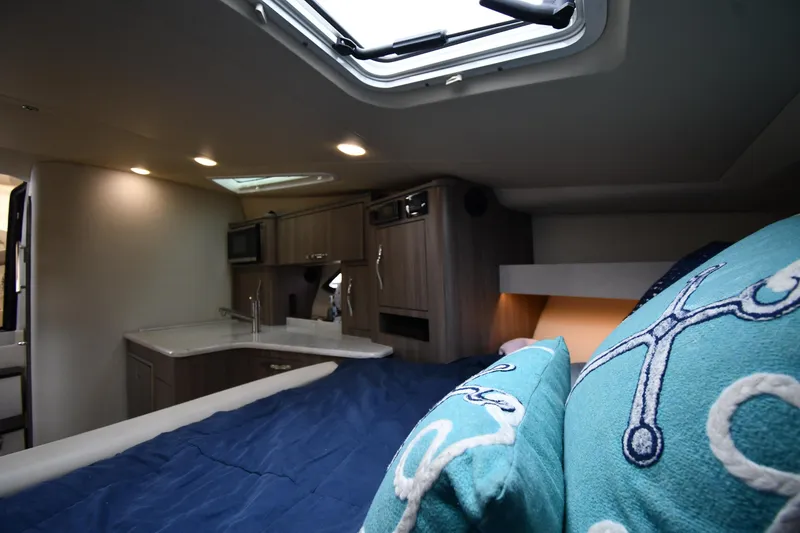 Slide: The Image of Interior of 2021 Regal 35 Sport Coupe with cozy bed and modern kitchenette. - 36