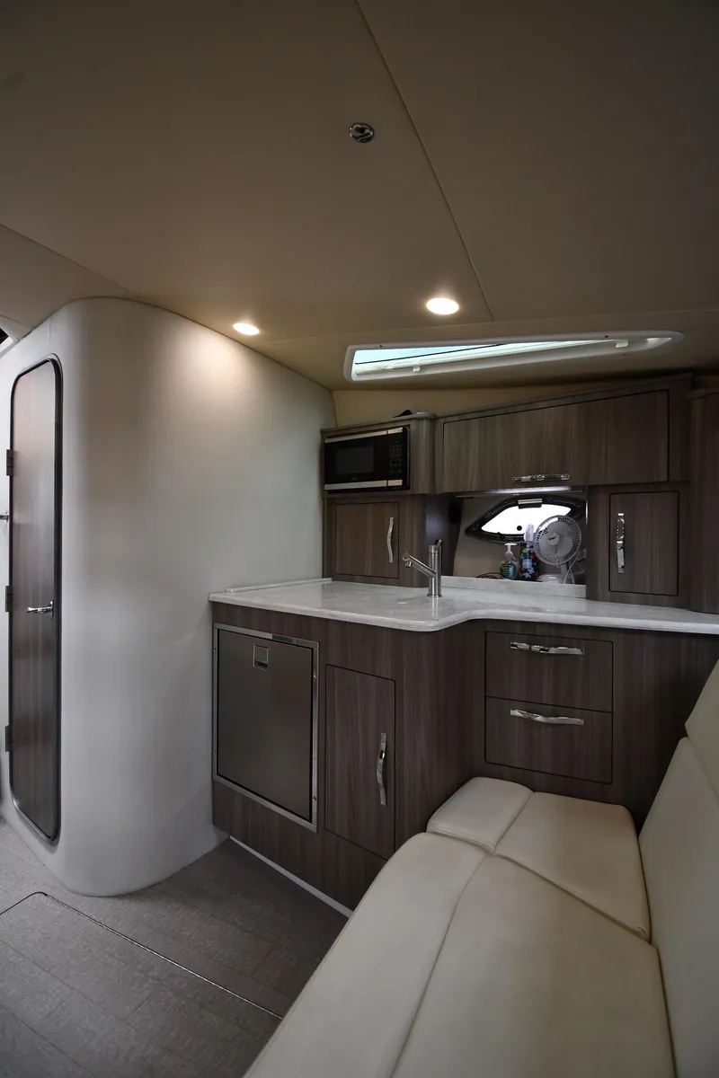 Slide: The Image of 2021 Regal 35 Sport Coupe interior with modern kitchenette and seating area. - 44
