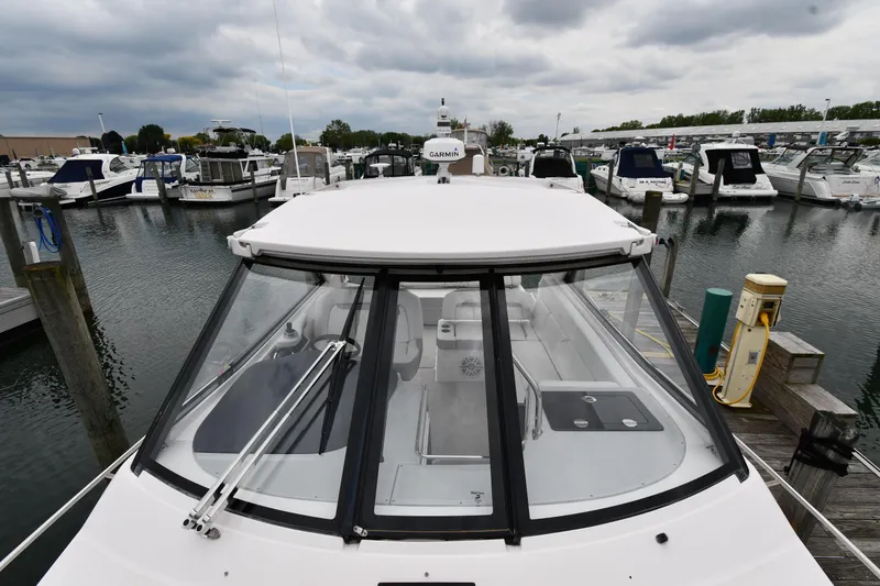 Slide: The Image of 2021 Regal 35 Sport Coupe docked at a marina under cloudy skies. - 7