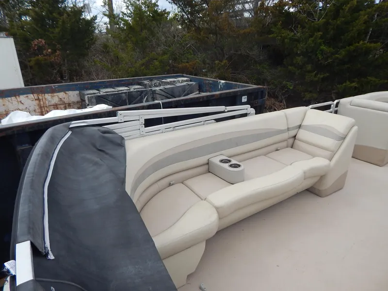Slide: The Image of 2016 Cypress Cay Seabreeze 230 pontoon boat with beige seating and cup holders. - 15