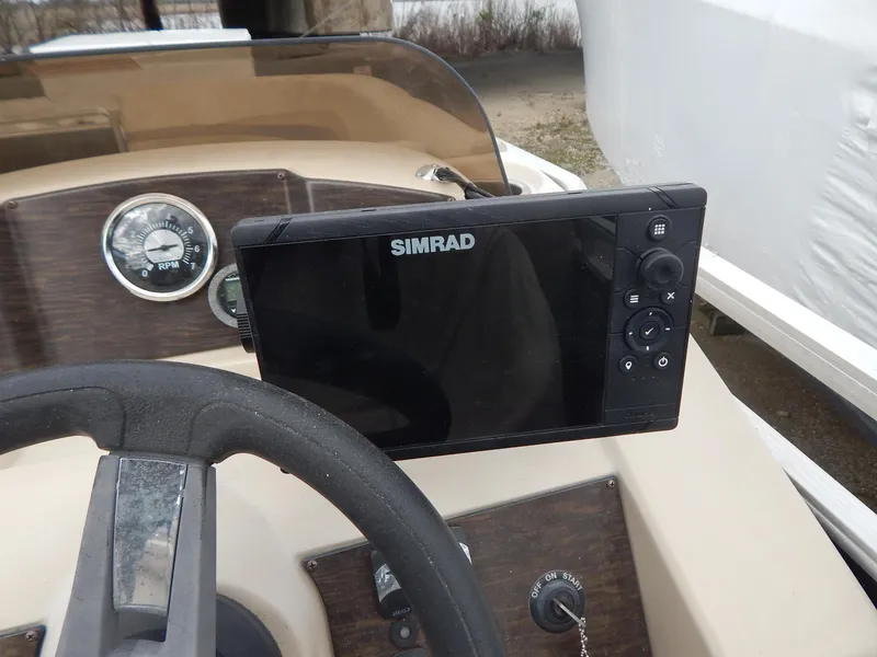 Slide: The Image of Steering console of 2016 Cypress Cay Seabreeze 230 with Simrad navigation system. - 19