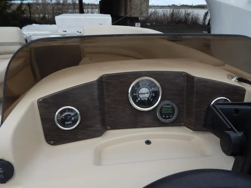 Slide: The Image of 2016 Cypress Cay Seabreeze 230 dashboard with fuel and RPM gauges. - 20