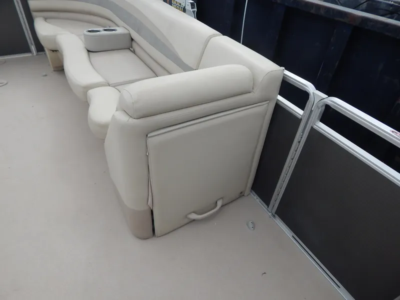 Slide: The Image of 2016 Cypress Cay Seabreeze 230 boat interior with beige seating and cup holders. - 27