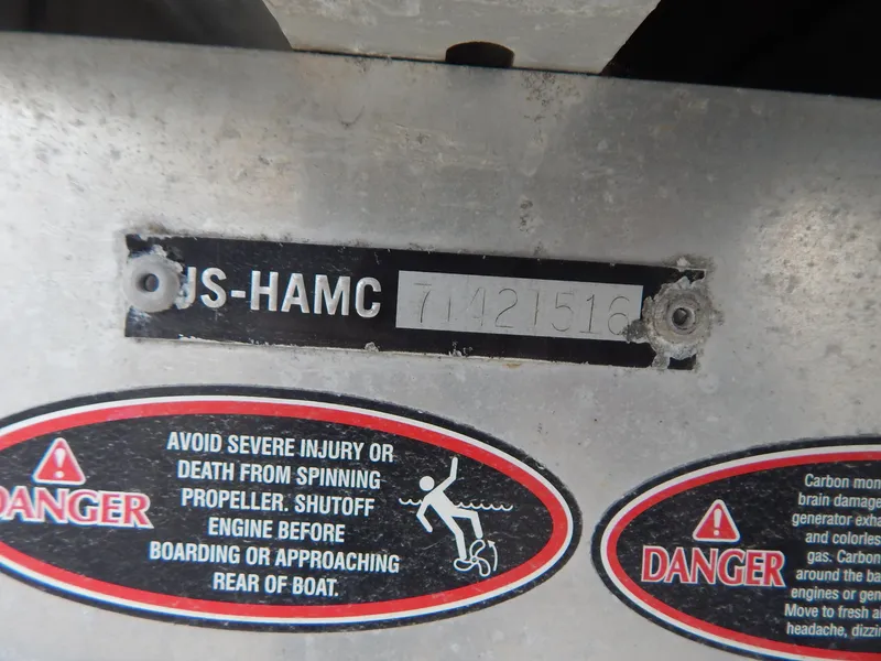 Slide: The Image of Hull identification number on a 2016 Cypress Cay Seabreeze 230 with safety warning labels. - 31