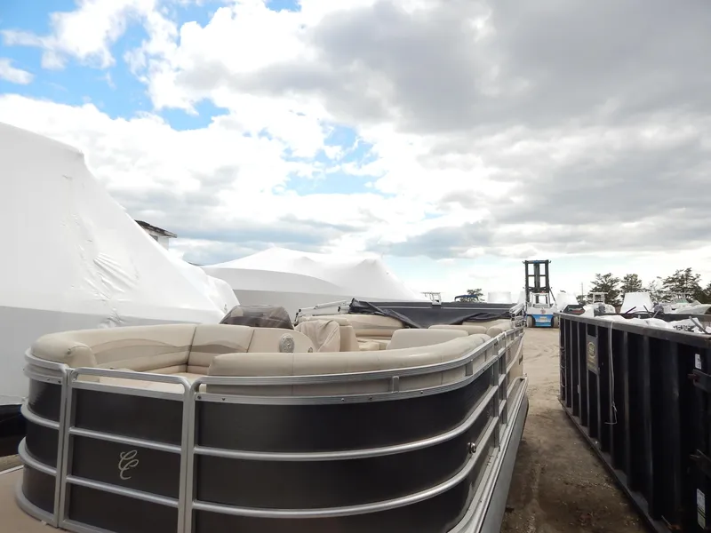 Slide: The Image of 2016 Cypress Cay Seabreeze 230 pontoon boat parked outdoors under cloudy sky. - 4