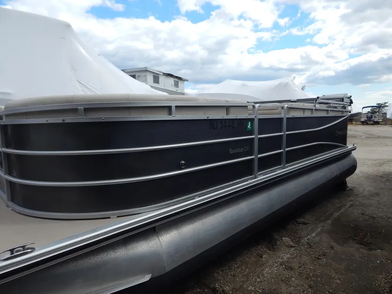 Slide: The Image of 2016 Cypress Cay Seabreeze 230 pontoon boat under cloudy sky. - 5