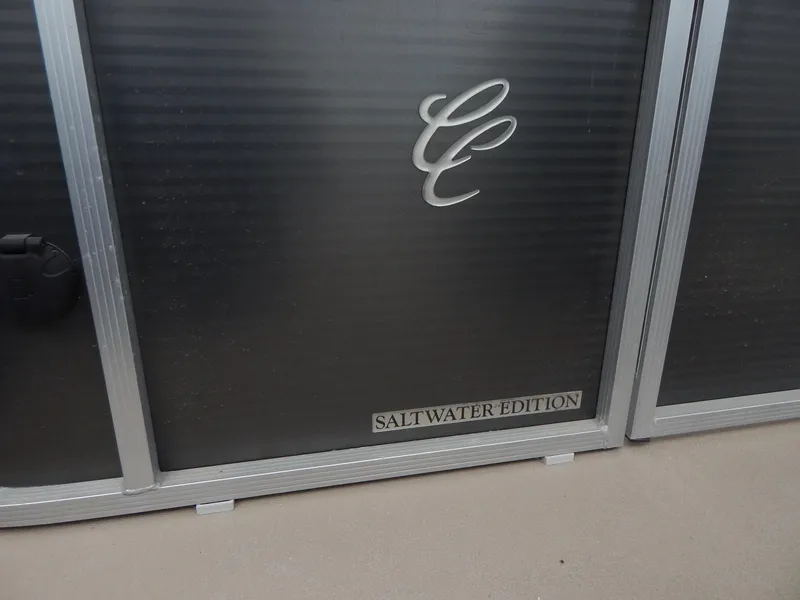 Slide: The Image of 2016 Cypress Cay Seabreeze 230 Saltwater Edition boat panel with logo. - 9