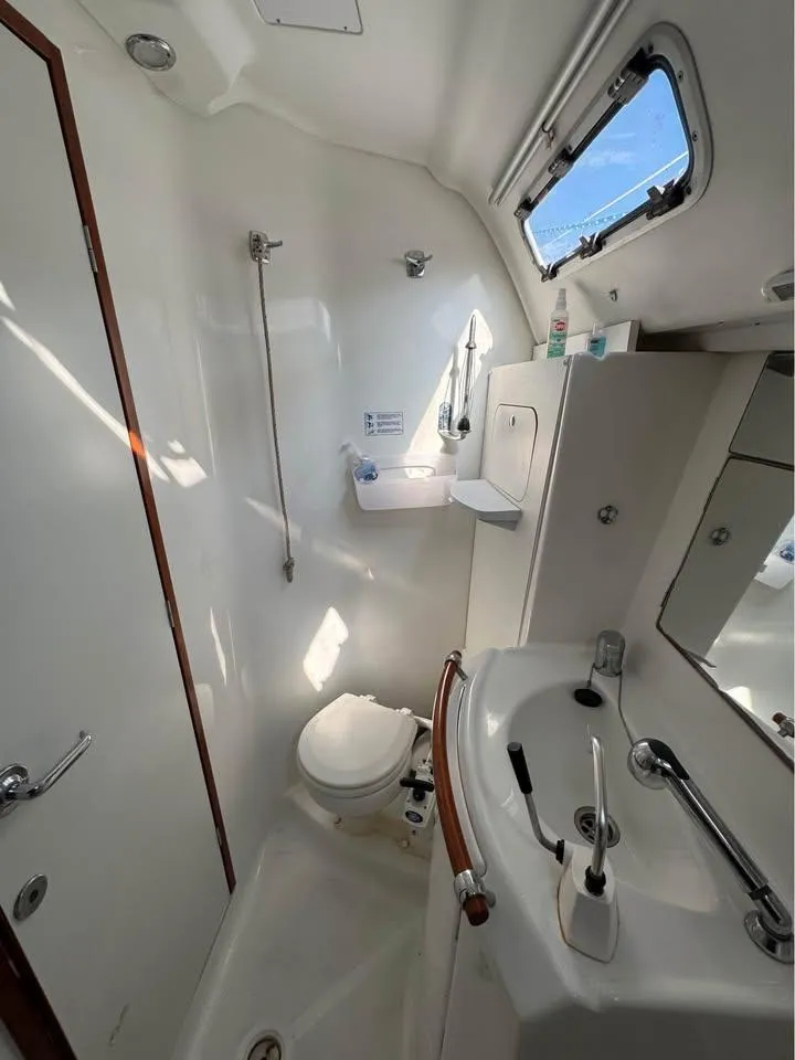 Slide: The Image of 2008 Beneteau Oceanis Clipper 343 bathroom with shower, sink, and toilet. - 19