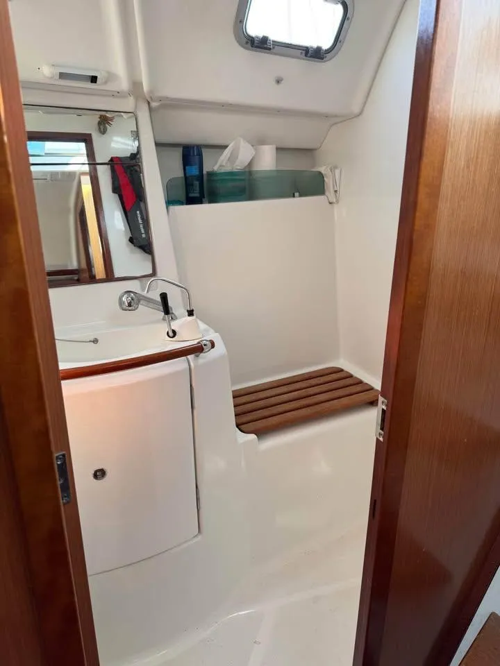 Slide: The Image of Beneteau Oceanis Clipper 343 bathroom with sink, mirror, and wooden accents, 2008 model. - 5