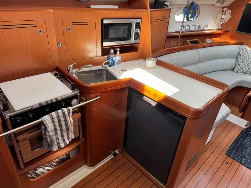 Slide: The Image of Interior of 2008 Beneteau Oceanis Clipper 343 yacht with kitchen and seating area. - 9