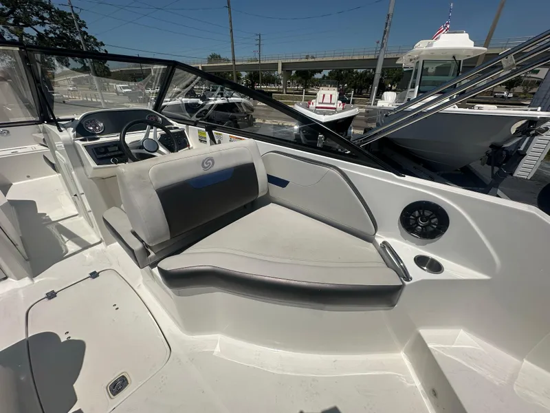 Slide: The Image of 2022 Hurricane SunDeck 235 OB boat interior with seating and steering console. - 11