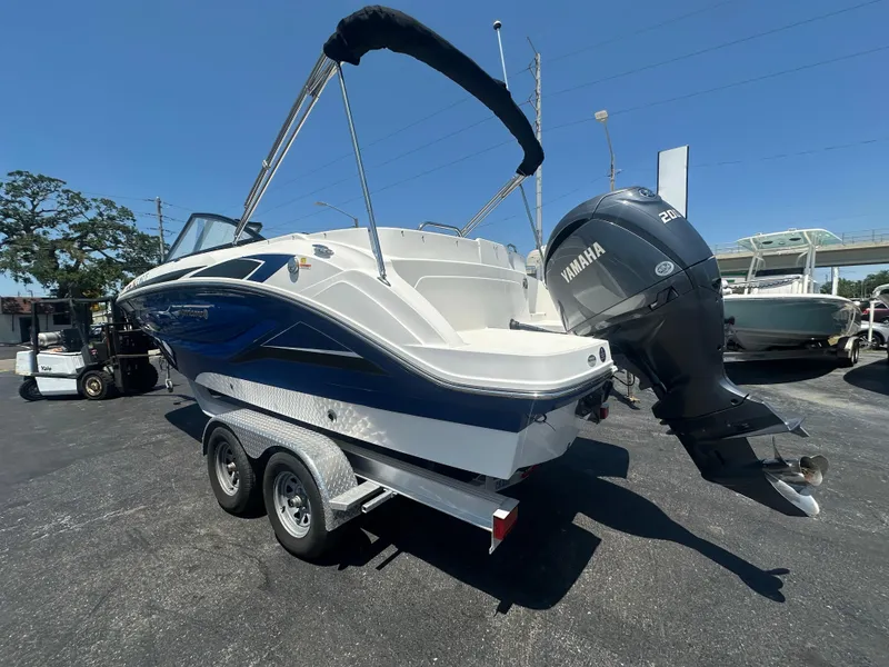 Slide: The Image of 2022 Hurricane SunDeck 235 OB boat with Yamaha outboard motor on a trailer. - 3