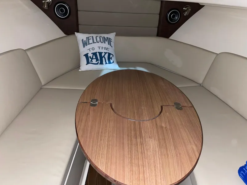 Slide: The Image of 2019 Boston Whaler 315 Conquest cabin with table and "Welcome to the Lake" pillow. - 18