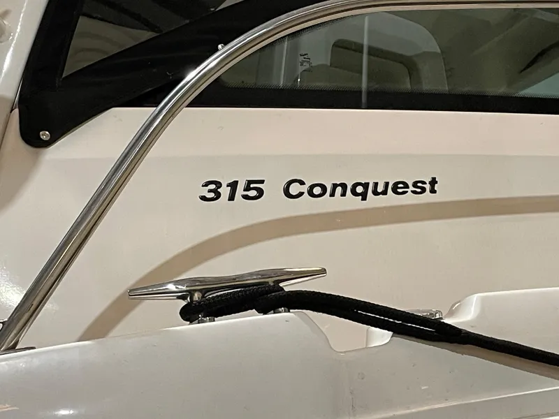 Slide: The Image of 2019 Boston Whaler 315 Conquest boat with sleek design and visible branding. - 2