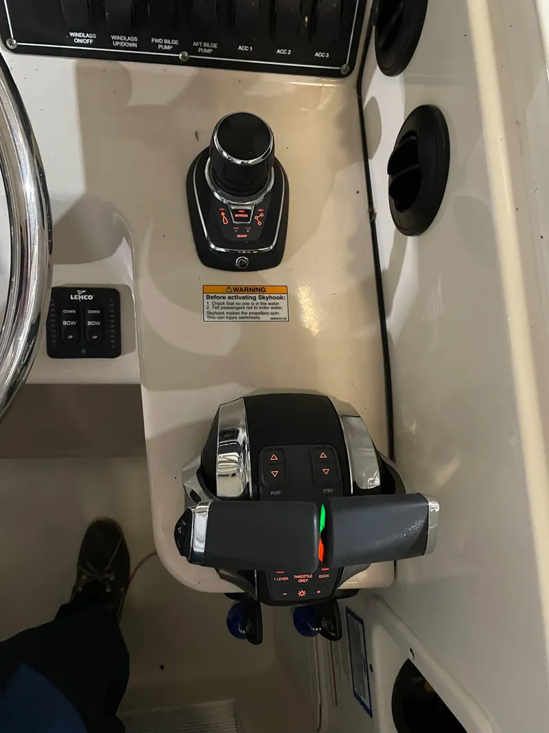 Slide: The Image of 2019 Boston Whaler 315 Conquest helm controls with joystick and throttle. - 20