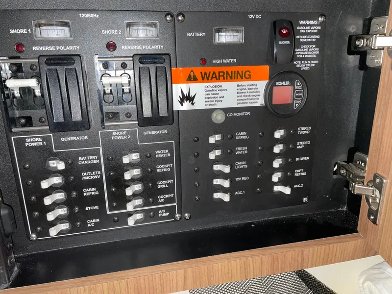 Slide: The Image of Electrical panel of a 2019 Boston Whaler 315 Conquest boat with warning labels. - 21
