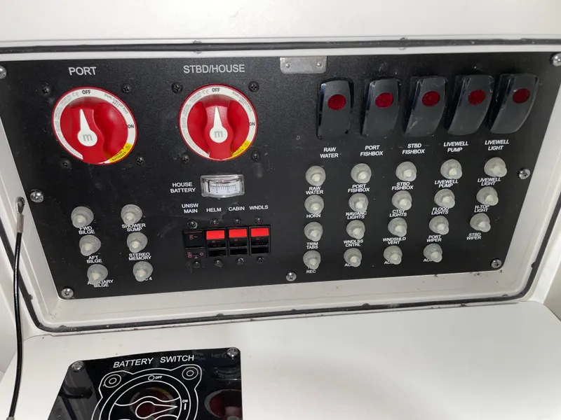 Slide: The Image of Control panel of a 2019 Boston Whaler 315 Conquest boat with switches and dials. - 26
