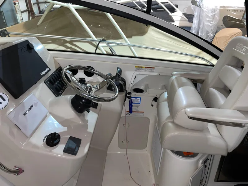 Slide: The Image of 2019 Boston Whaler 315 Conquest helm with steering wheel and navigation equipment. - 7