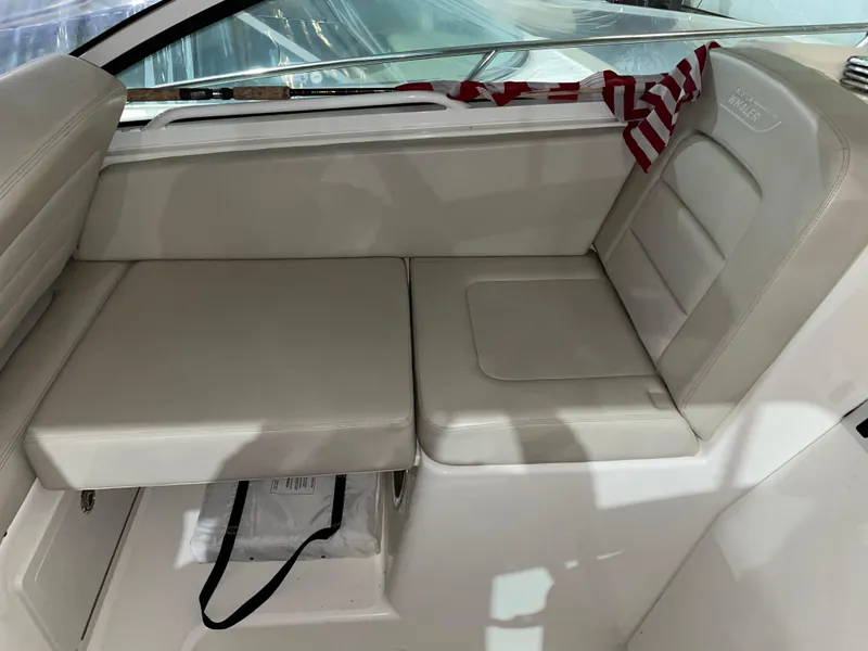Slide: The Image of 2019 Boston Whaler 315 Conquest interior seating with beige upholstery. - 8