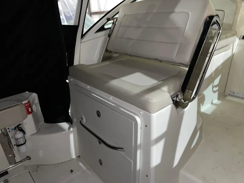 Slide: The Image of 2019 Boston Whaler 315 Conquest interior seating with storage compartments. - 9