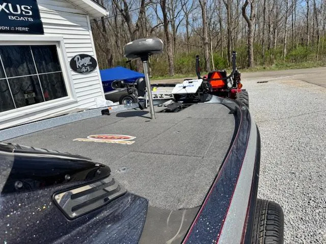 Slide: The Image of 2020 Ranger Z520C boat on gravel, near dealership, with trees in background. - 6