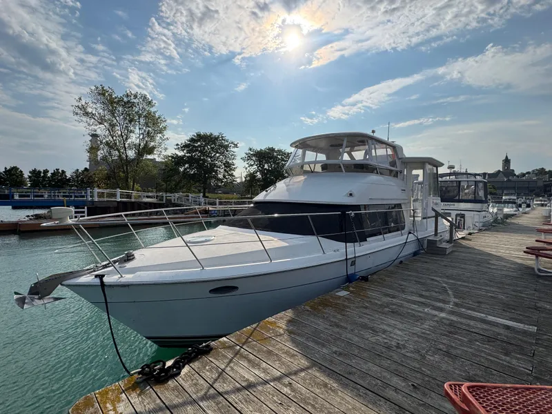 Slide: The Image of 2000 Carver 504 Cockpit Motor Yacht docked under a sunny sky. - 0