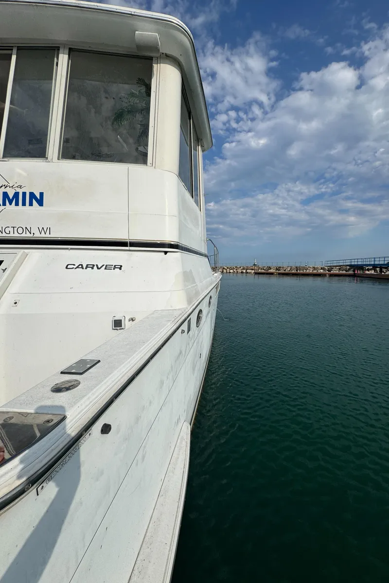 Slide: The Image of 2000 Carver 504 Cockpit Motor Yacht docked on a sunny day. - 10