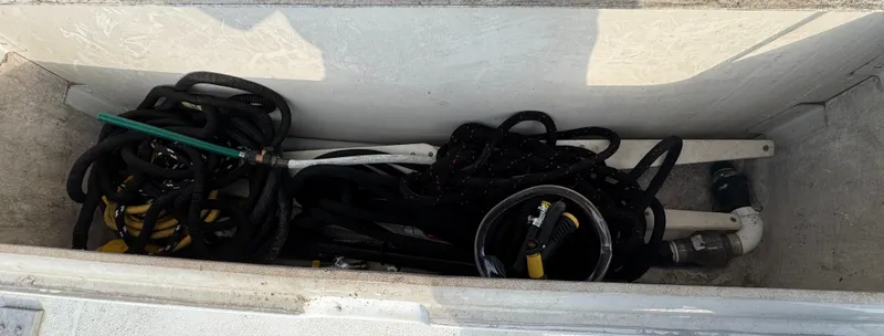 Slide: The Image of Storage compartment on a 2000 Carver 504 Cockpit Motor Yacht with ropes and equipment. - 6