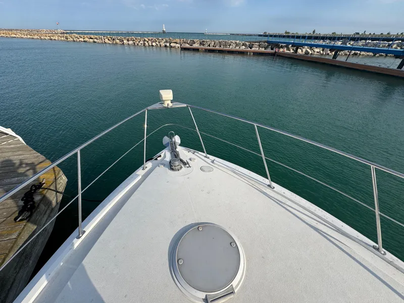 Slide: The Image of Bow view of 2000 Carver 504 Cockpit Motor Yacht in a marina setting. - 7